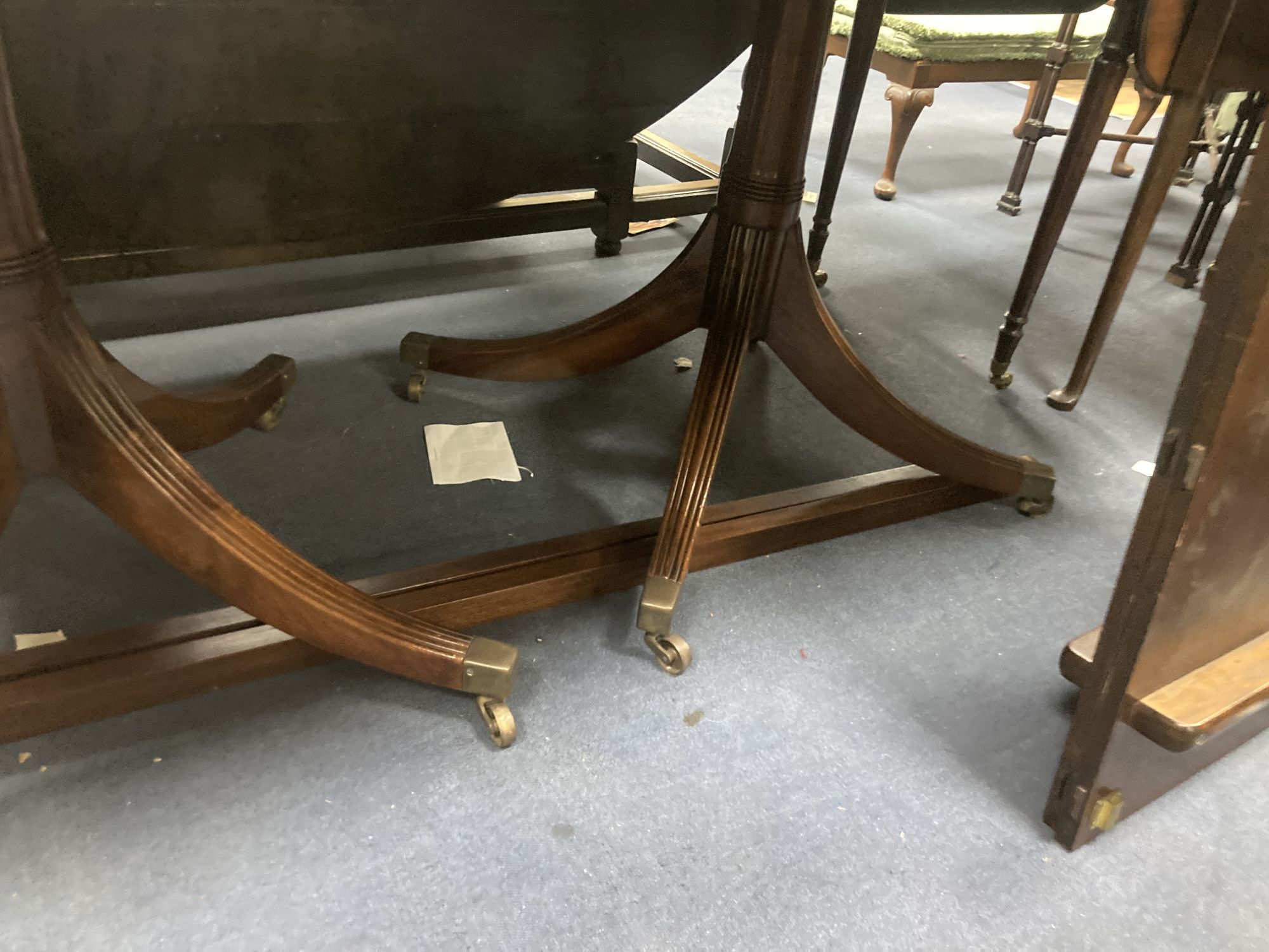 A George III style mahogany twin pedestal dining table, with two spare leaves, length 175cm, depth 106cm, height 71cm